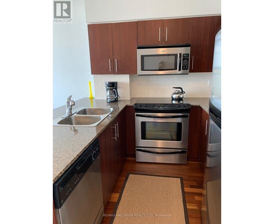 A modern kitchen with a stainless steel oven and microwave.