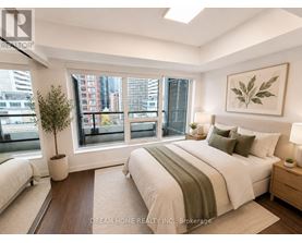 A bedroom with a large bed and a view of the city.