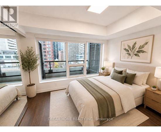A bedroom with a large bed and a view of the city.