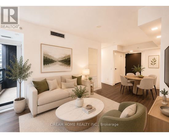 A modern living room with a large painting on the wall and a dining area in the background.