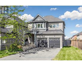 A large house with a grey roof and a garage door.