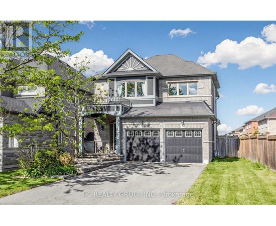 A large house with a grey roof and a garage door.
