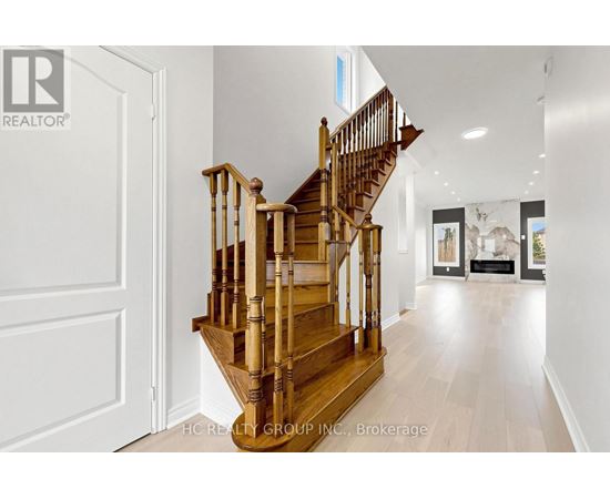 A wooden staircase in a house leads to the second floor.