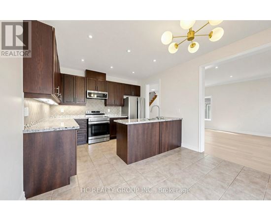 A modern kitchen with dark wood cabinets and a central island.