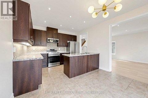 A modern kitchen with dark wood cabinets and a central island.