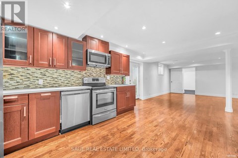 A kitchen with wooden cabinets and a stone backsplash.