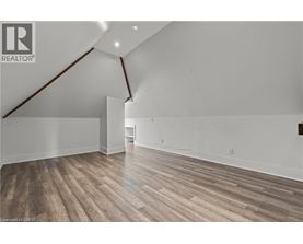 A room with wooden flooring and white walls.