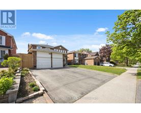 A sunny day in a residential neighborhood with a house for sale.