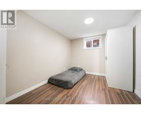 A bedroom with a bed and a window.