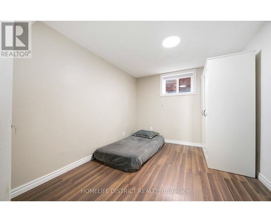 A bedroom with a bed and a window.