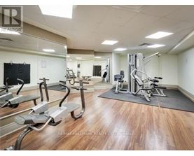 A gym with a variety of exercise equipment including treadmills, stationary bikes, and weight machines.