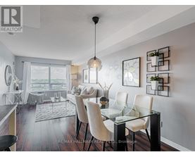 A modern dining room with a glass table and chairs.