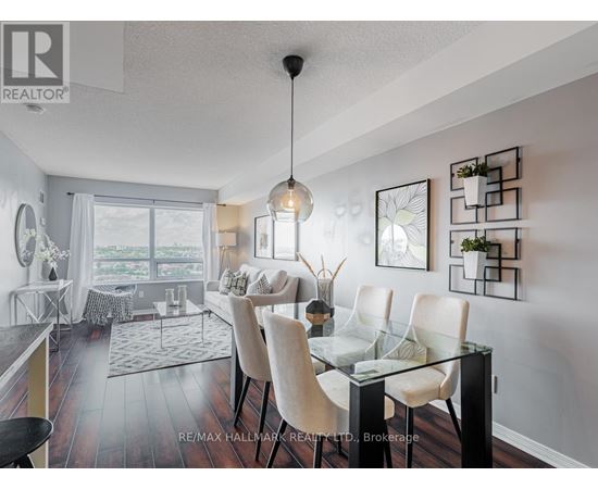 A modern dining room with a glass table and chairs.