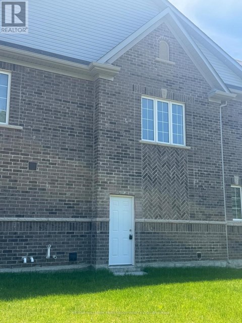 A brick building with a white door and windows.