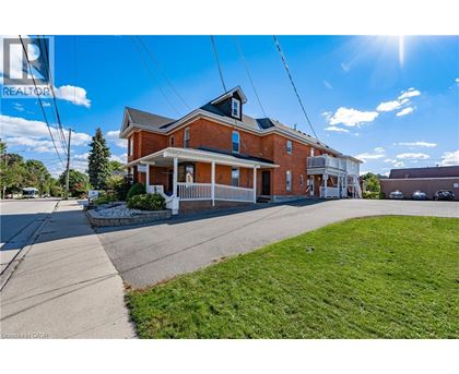 A house with a blue sign that says REALTOR in the background.