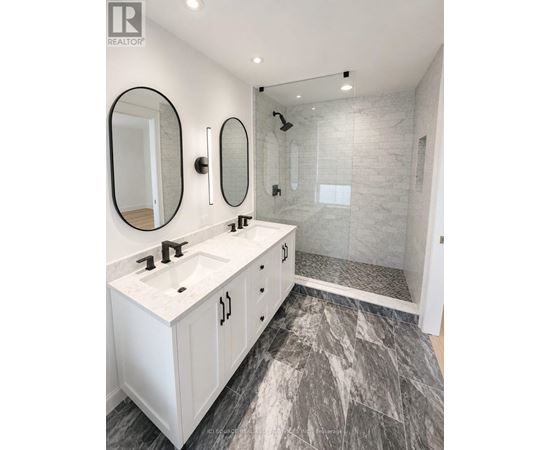 A bathroom with a marble floor and white walls.