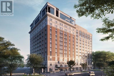 A large, modern building with a glass facade is depicted in the image.