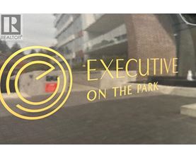A logo with the text "EXECUTIVE ON THE PARK" in front of a blurry background.