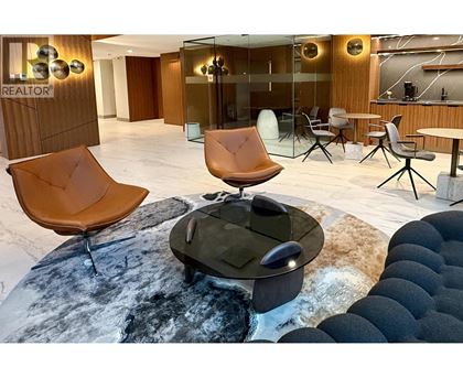 A modern office space with a glass wall and wooden accents.