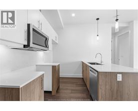 A modern kitchen with wooden cabinets and a white countertop.