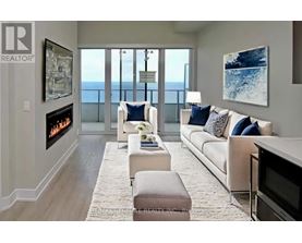 A living room with a fireplace and a view of the ocean.