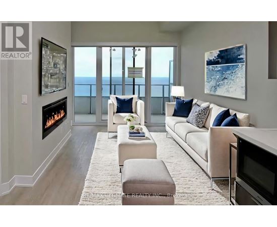 A living room with a fireplace and a view of the ocean.