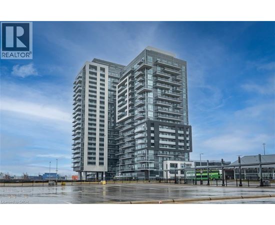A tall, modern building with many windows is the focal point of the image.