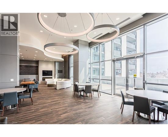 A modern dining area with a large table and chairs.