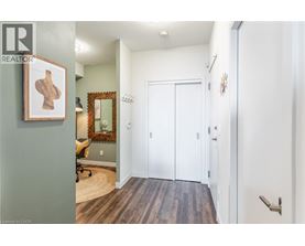 A hallway with a white door and a mirror on the wall.
