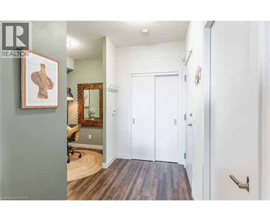 A hallway with a white door and a mirror on the wall.