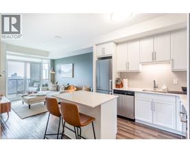 A modern kitchen with white cabinets and a large island.