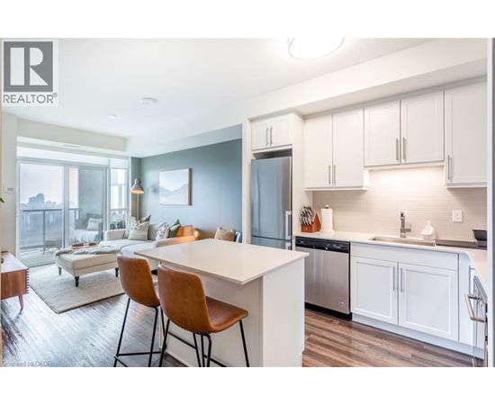 A modern kitchen with white cabinets and a large island.