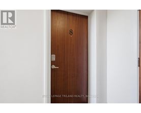 A brown door with a number 8 on it.