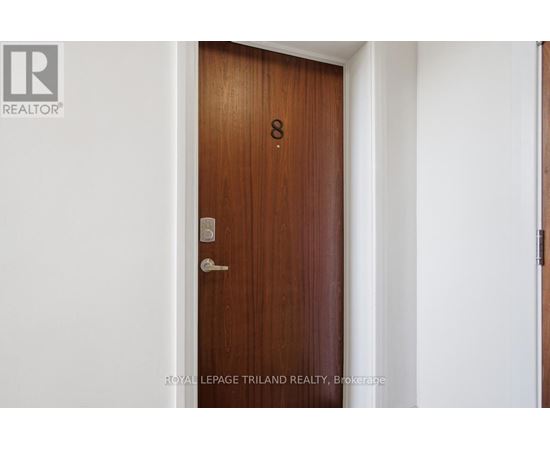 A brown door with a number 8 on it.