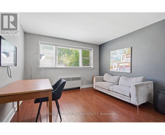 A living room with a couch, chair, and table.