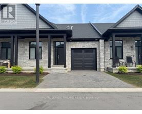 A house with a sign that says REALTOR in front of it.