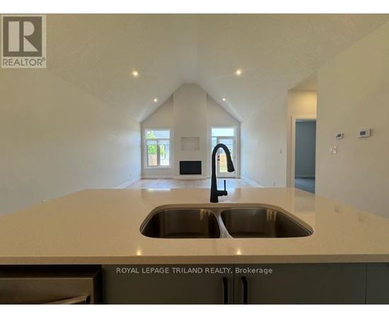 A modern kitchen with a sink and a window.
