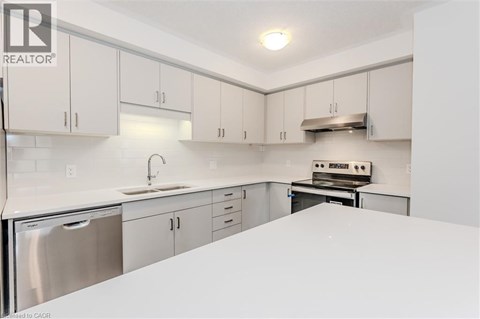 A kitchen with white cabinets and appliances.