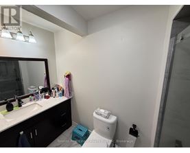 A bathroom with a sink, mirror, and toiletries.