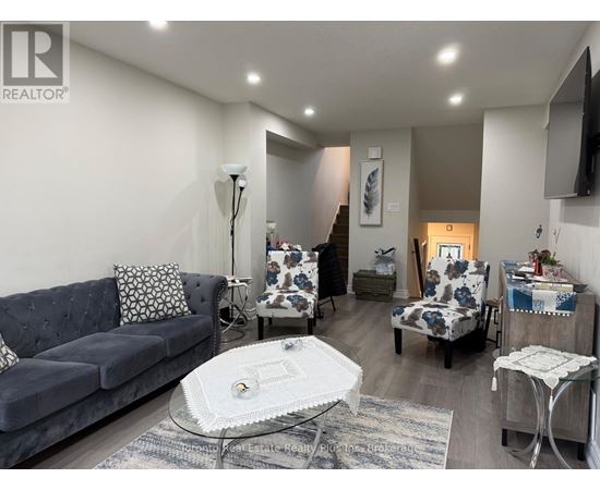 A living room with a grey couch and a white coffee table.