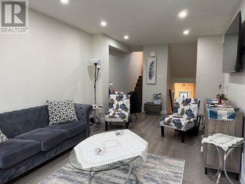 A living room with a grey couch and a white coffee table.