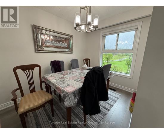 A dining room with a table, chairs, and a window.