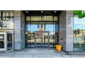 Store front with glass doors and a yellow bucket on the sidewalk.
