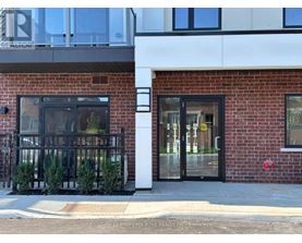 A building with a red brick facade and a glass door.