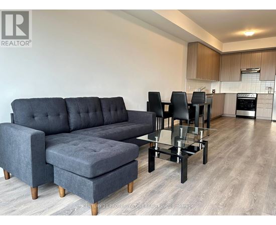 A grey sofa and ottoman in a modern living room.