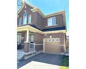 A house with a brown brick exterior and a tan garage door.