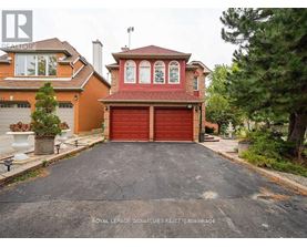A house with a red garage door is for sale.