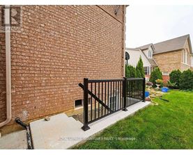 A black metal railing on a brick wall.