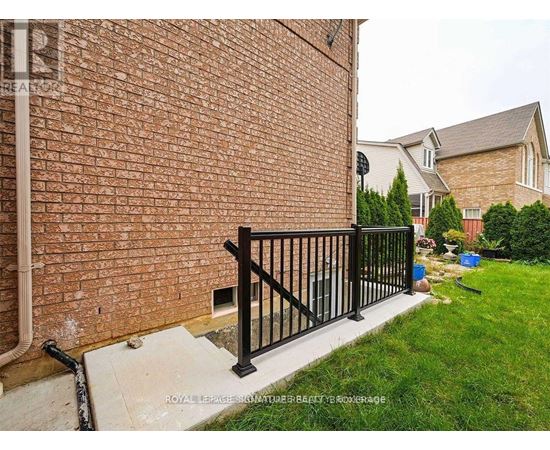 A black metal railing on a brick wall.