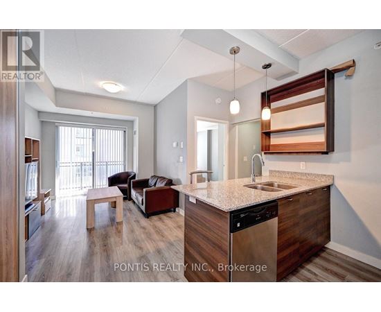 A kitchen area with a sink and a counter.